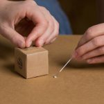 How do carded figures differ from blind boxes in auction grading